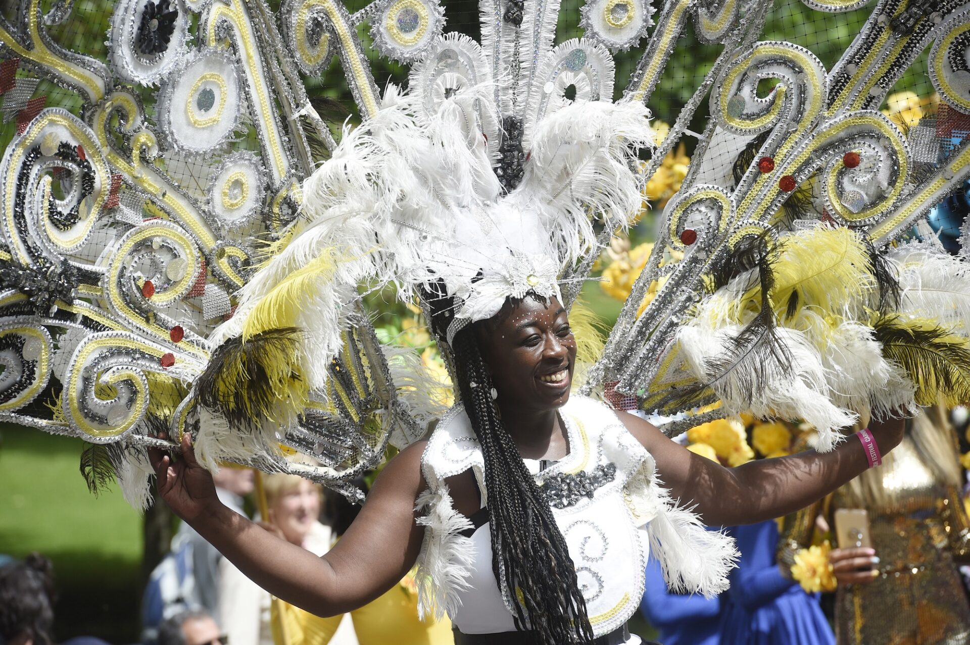 Person in a white carnival costume, smiling.