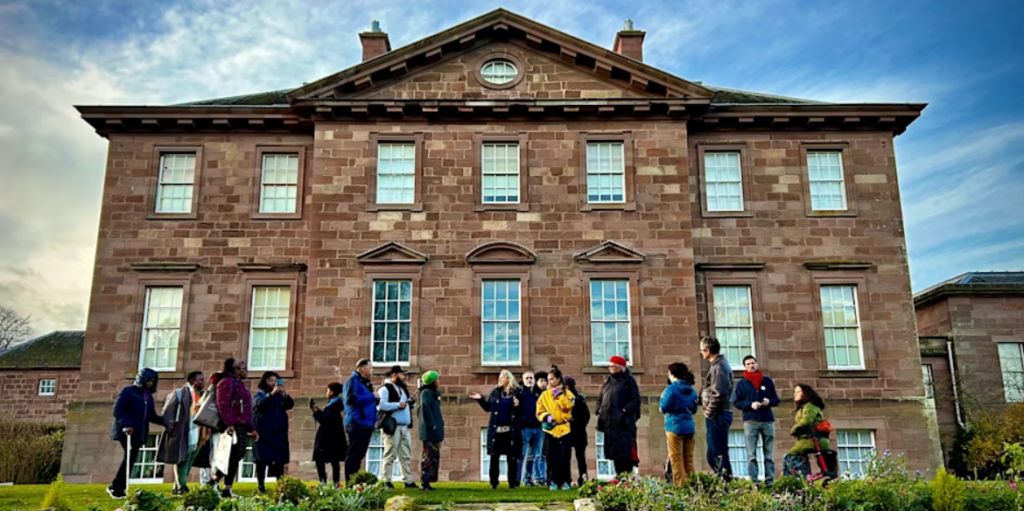 Photo of a group of people standing outside Paxton House.
